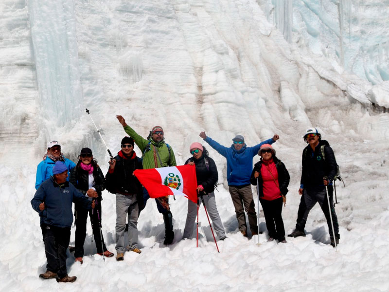people in the snow with the flag of peru